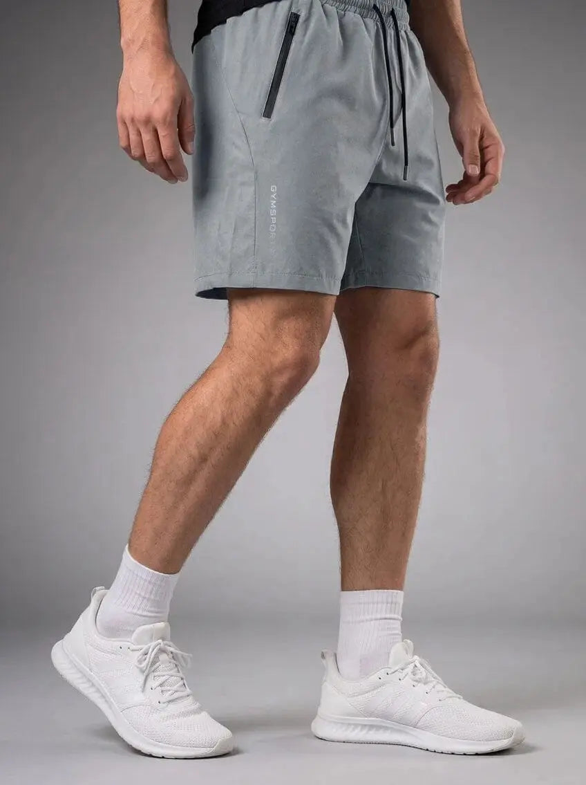 Rear view of men’s light gray athletic shorts with elastic waistband and back pockets