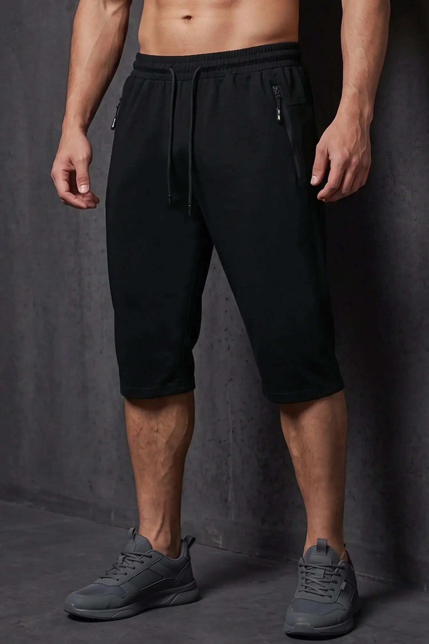 Men’s black casual shorts with elastic waistband, drawstring and zipper pockets