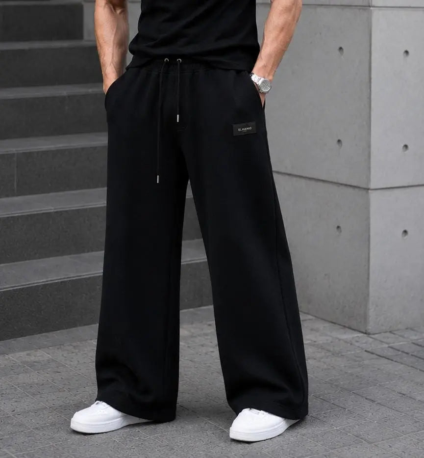 WEARO men's black relaxed-fit cargo joggers styled with a casual streetwear outfit.