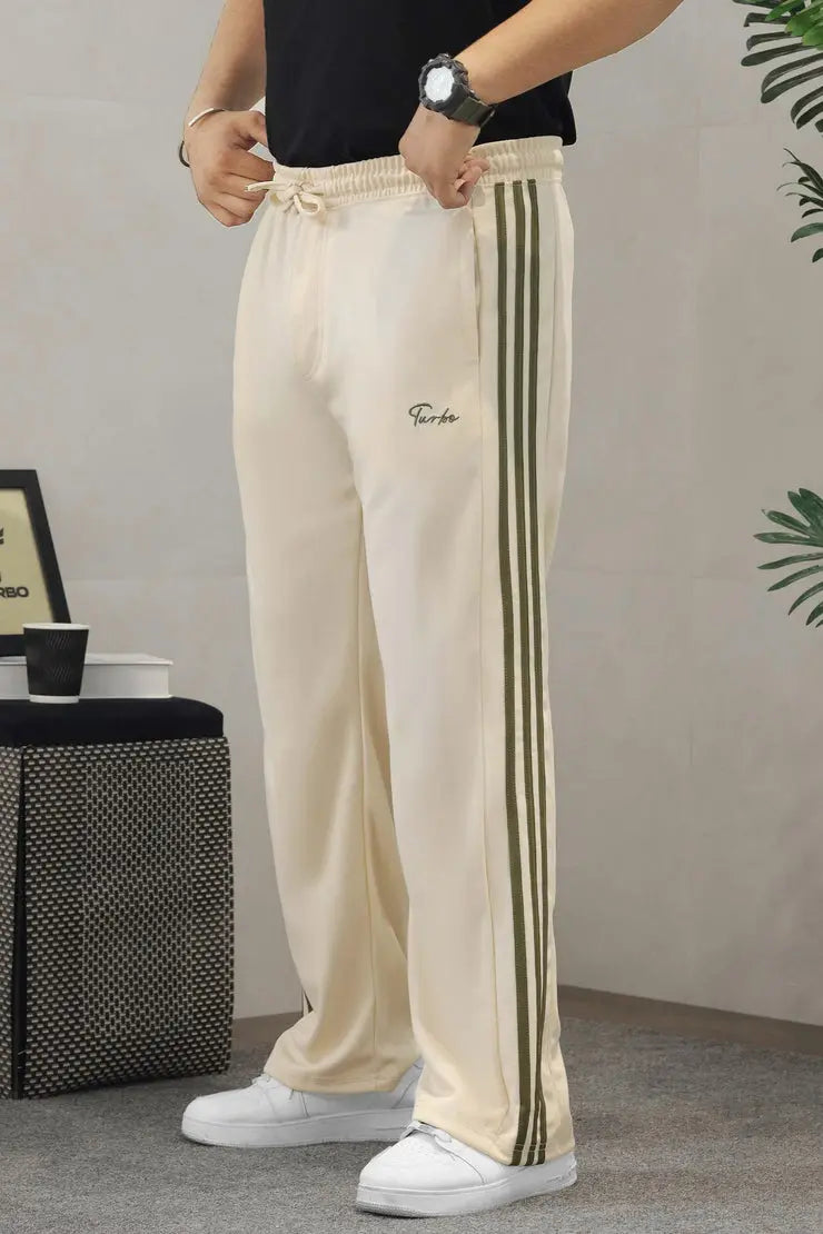 Men’s black wide-leg track pants with olive-green side stripes, styled with a white T-shirt and white sneakers.